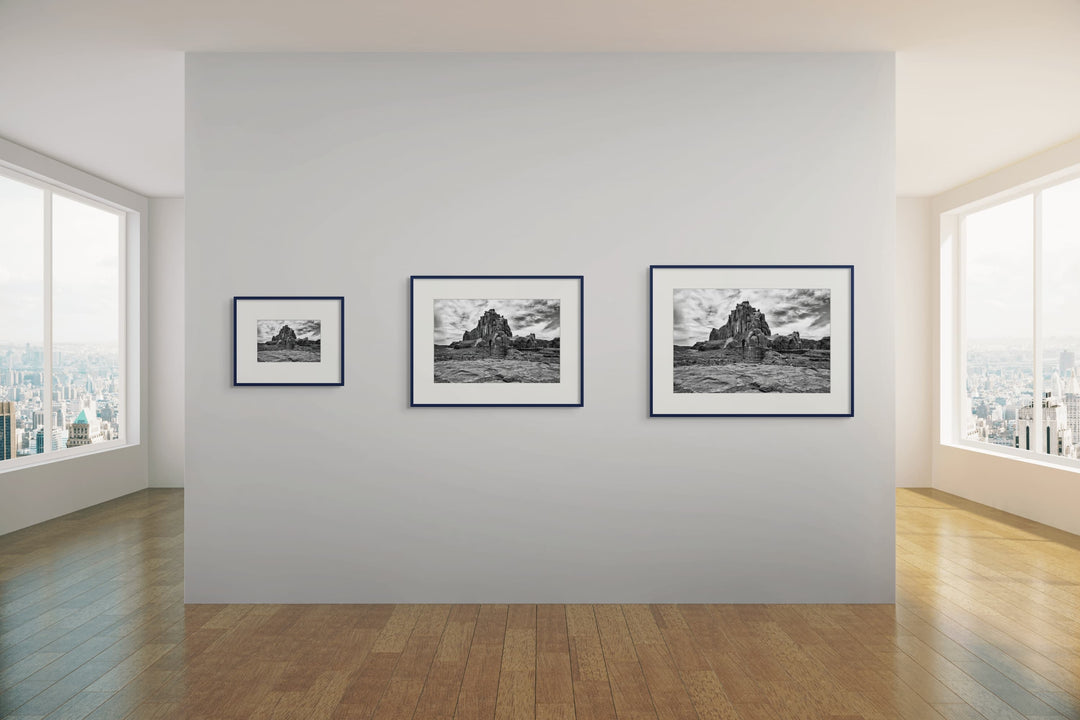 Multiple sizes of photography art prints on a gallery wall. 